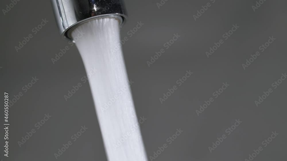 Water flow from the tap. Mixer in the kitchen. Pure clear drinking water. Water flow from the tap. Mixer in the kitchen. Pure clear drinking water.