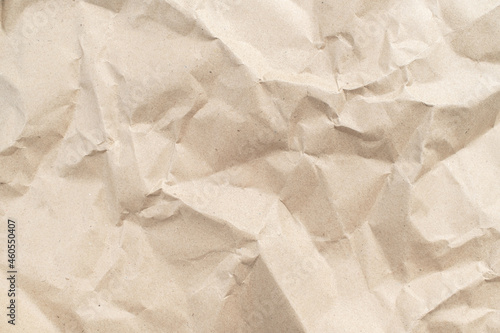 Recycled brown creased paper background from a paper packing. Crumpled brown paper texture concept