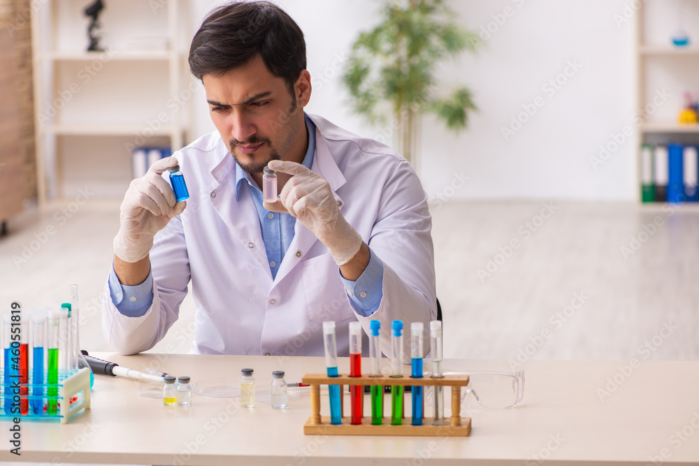 Young male chemist working at the lab Young male chemist working at the lab