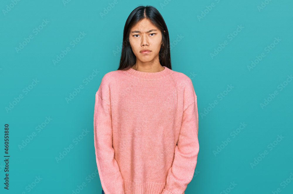 Fototapeta premium Beautiful young asian woman wearing casual winter sweater depressed and worry for distress, crying angry and afraid. sad expression.