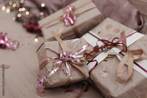 Close up of Christmas gifts wrapped in craft paper.