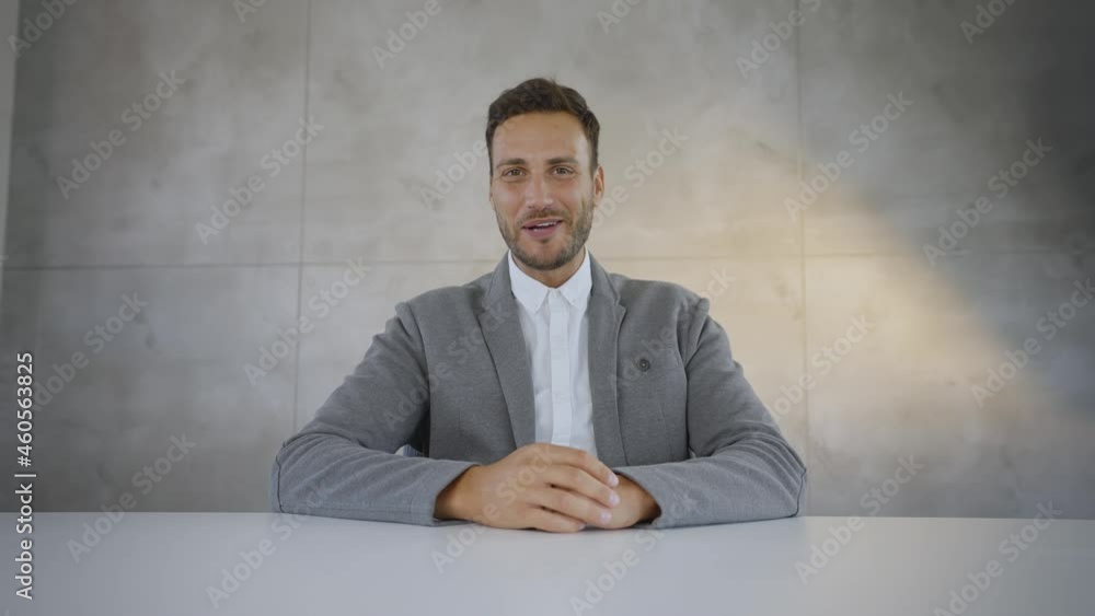 Cheerful mid adult Caucasian man looking at camera and talking. Waving to camera during online video call. Cheerful mid adult Caucasian man looking at camera and talking. Waving to camera during online video call.