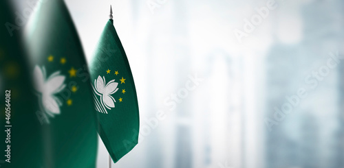 Small flags of Macao on a blurry background of the city