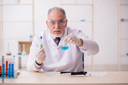 Old male chemist working in the lab