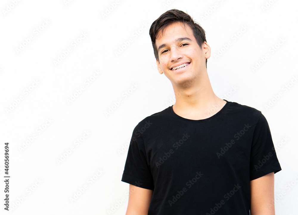 One positive teenage boy portrait against wall One positive teenage boy portrait against wall