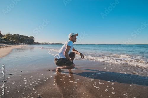 
Asian man taking a photo shoot at campbells bay beach, Auckland, New Zealand