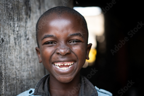 Cute happy poor black child at home