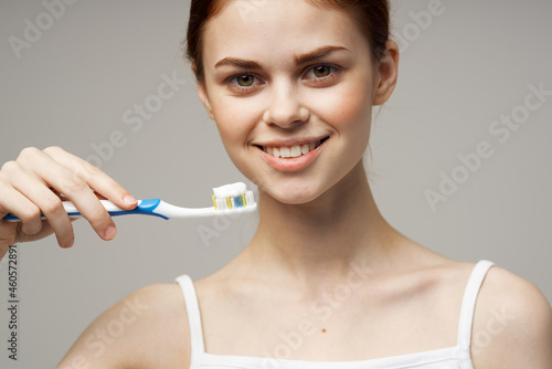 cheerful woman toothpaste brushing teeth dental health studio lifestyle