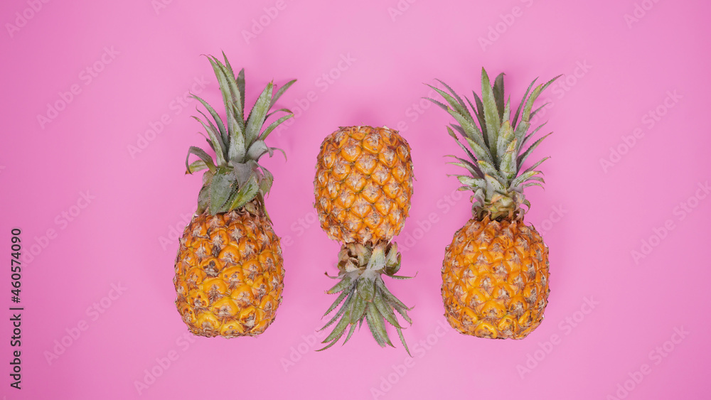 a few pineapples isolated on a pink background a few pineapples isolated on a pink background