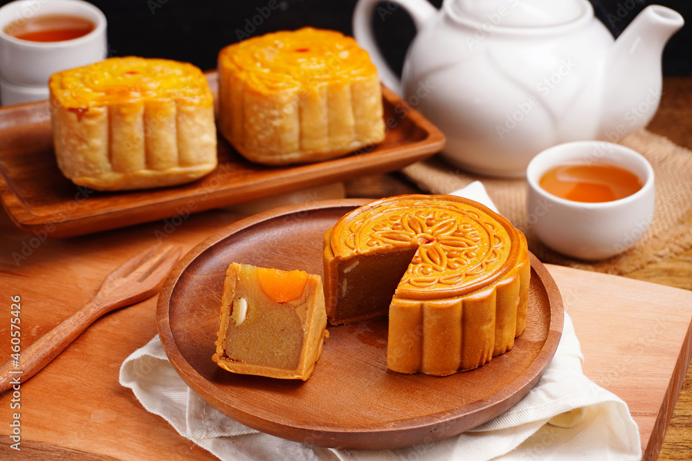 Mooncakes Stir Fried Durian Filling with Salted Egg Yolk and hot tea Asian Festival Mooncakes Stir Fried Durian Filling with Salted Egg Yolk and hot tea Asian Festival