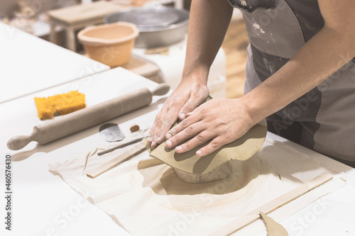Ceramic artist prepare clay for mold at table. Creative handmade craft