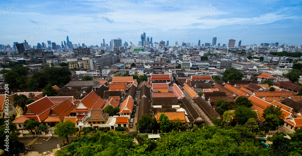 Wide angle view from a bird's eye view of the old city of Bangkok, Wat Phukhao Thong in the background is a tall building in the business district of Silom, Sathorn.