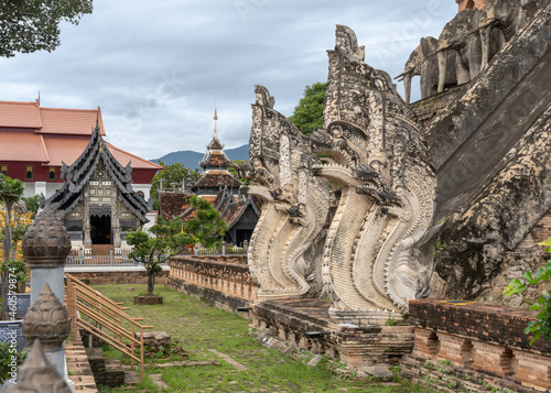 Base of main stupa with beautiful ancient naga and elephant stucco decor at Wat Chedi Luang buddhist temple, famous landmark of Chiang Mai, Thailand
