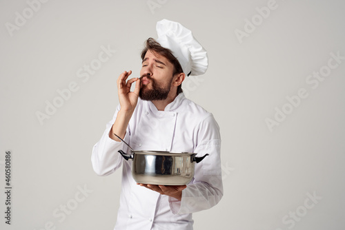 emotional male chef with a saucepan in his hands cooking restaurant industry photo
