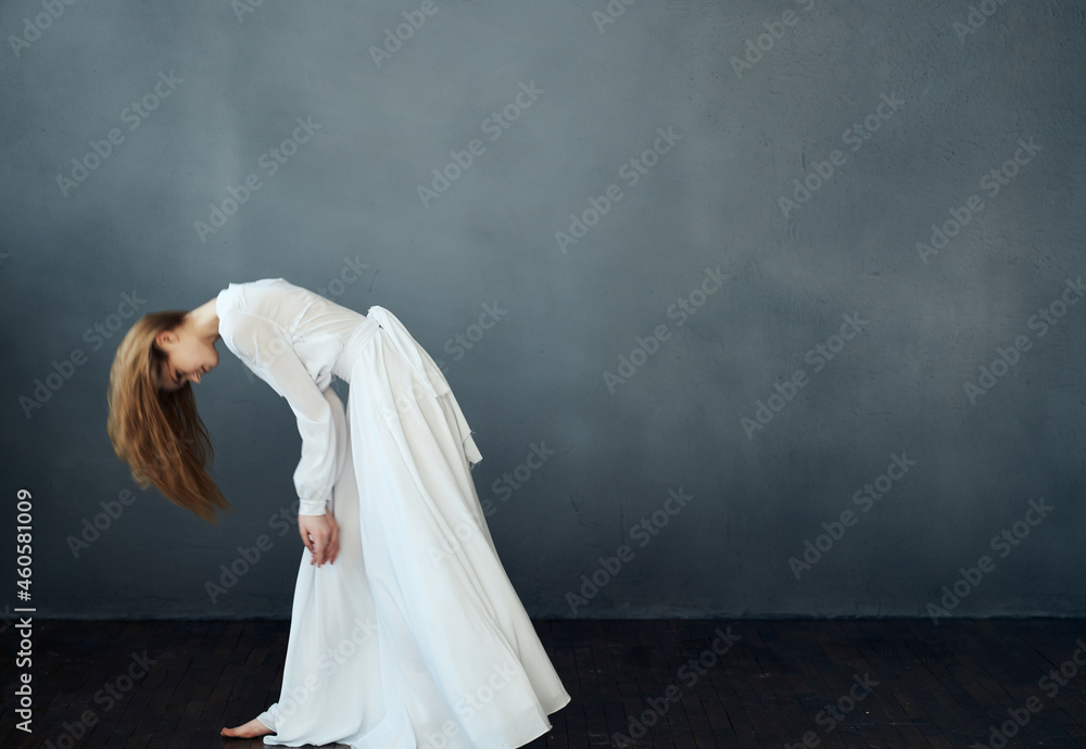 Woman in white dress dance performing dark background Woman in white dress dance performing dark background