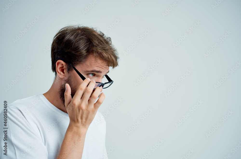 bearded man with poor eyesight health problems light background bearded man with poor eyesight health problems light background