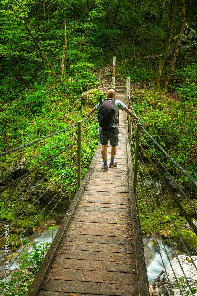 Adventure Man on Suspension Bridge in Tolmin Gorge Canyon in Soca Valley, Slovenia