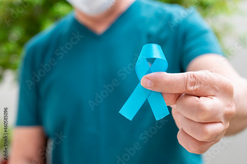 man holding blue ribbon. Blue november. Prostate Cancer Prevention Month. Men's health. blue march, colorectal cancer prevention campaign photo