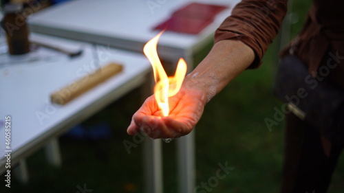 Magic of chemistry flaming hand, lighting and holding a small fire in your hand with butane-filled soap bubbles photo