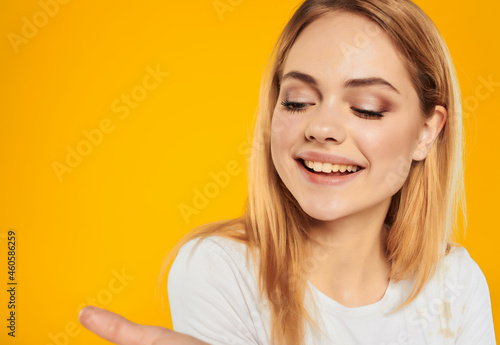 cheerful woman in a white attractive look happy Lifestyle yellow background