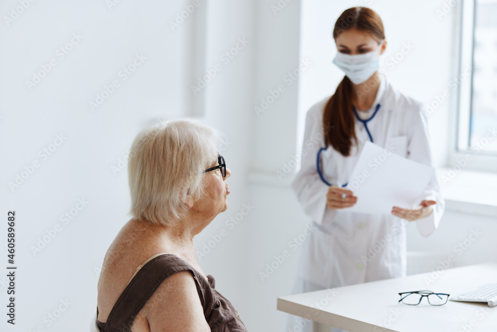 Fototapeta premium elderly woman patient on examination by a nurse health diagnostics