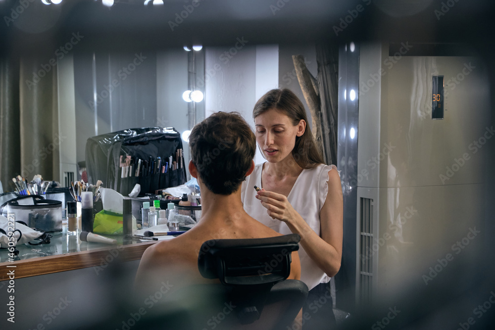 Professional male model at make up before studio photo shooting Professional male model at make up before studio photo shooting