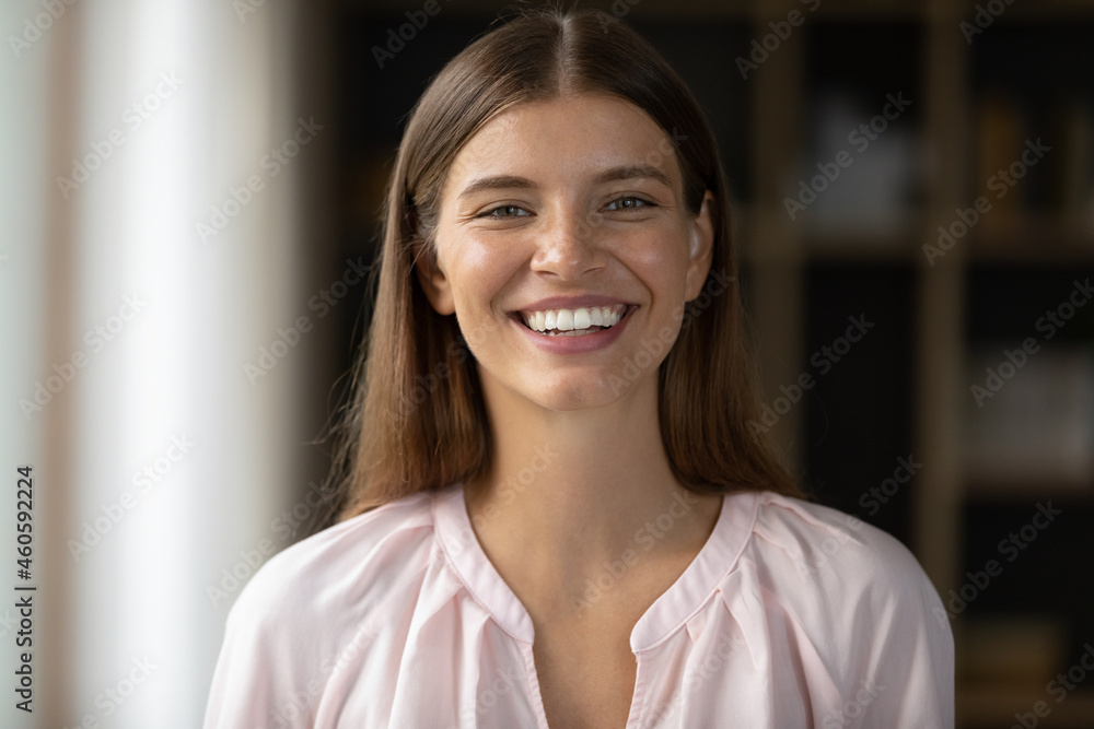 Happy beautiful young Caucasian woman with perfect white teeth looking at camera, laughing. Millennial teen student girl in casual female home head shot portrait. Dentistry, beauty care concept Happy beautiful young Caucasian woman with perfect white teeth looking at camera, laughing. Millennial teen student girl in casual female home head shot portrait. Dentistry, beauty care concept