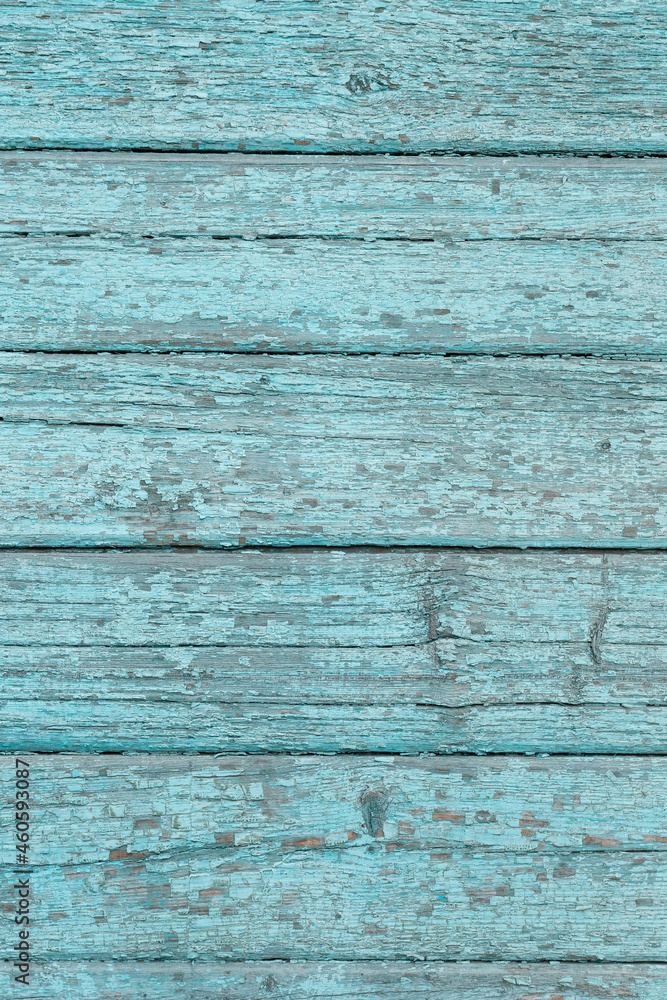 A piece of a wooden wall and a cracked blue paint A piece of a wooden wall and a cracked blue paint