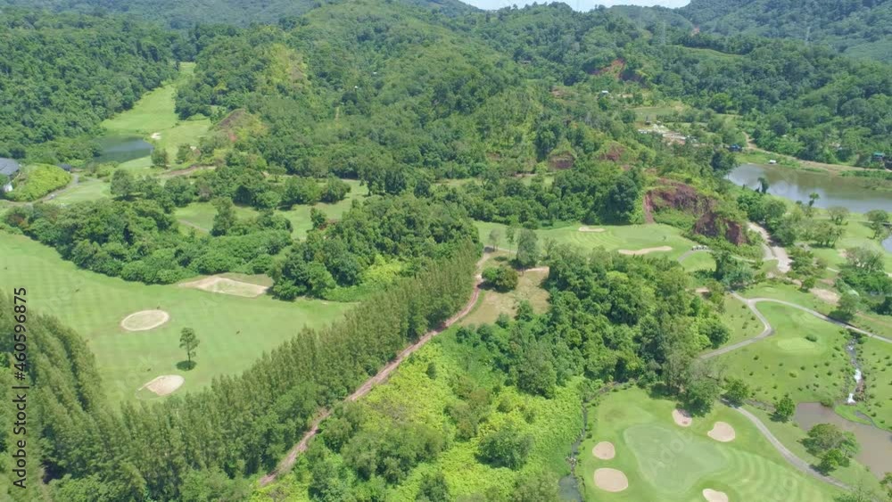 Aerial view Top down of the green golf course in Thailand Beautiful green grass and trees on a golf field with fairway and putting green in summer season Aerial view Top down of the green golf course in Thailand Beautiful green grass and trees on a golf field with fairway and putting green in summer season