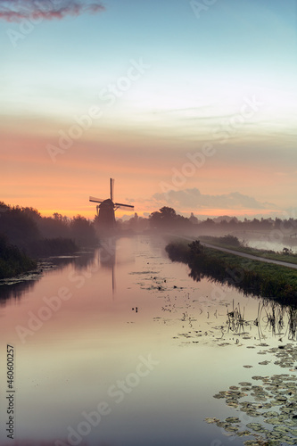Calm and foggy sunrise morning on the Hazerswouder-Dorp windmill, Rietveldse, Netherlands.