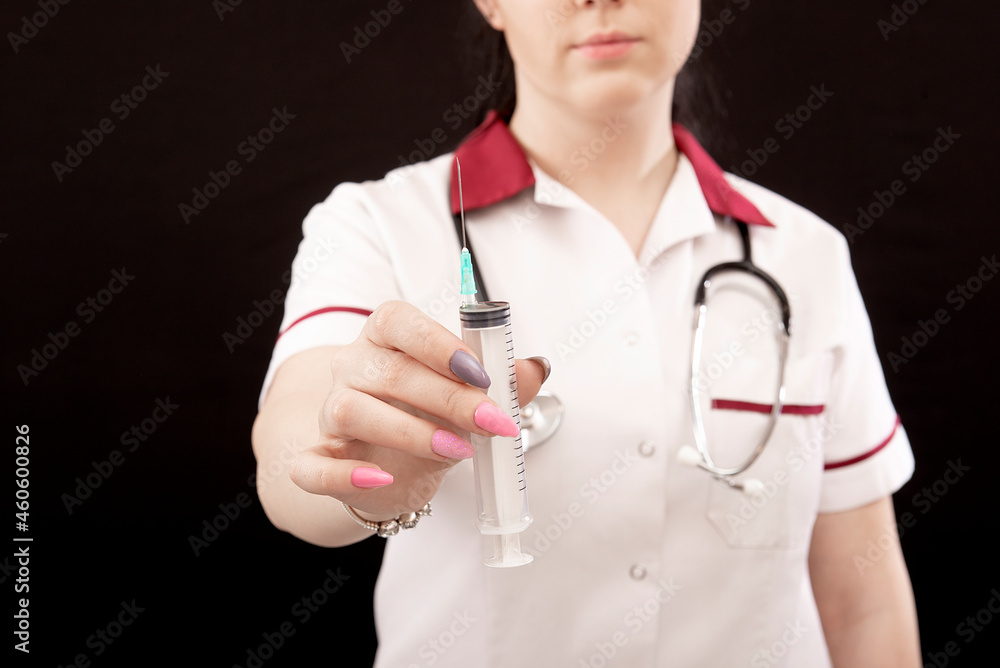 closeup of female nurse with stethoscope and syringe over dark background, vaccination concept closeup of female nurse with stethoscope and syringe over dark background, vaccination concept