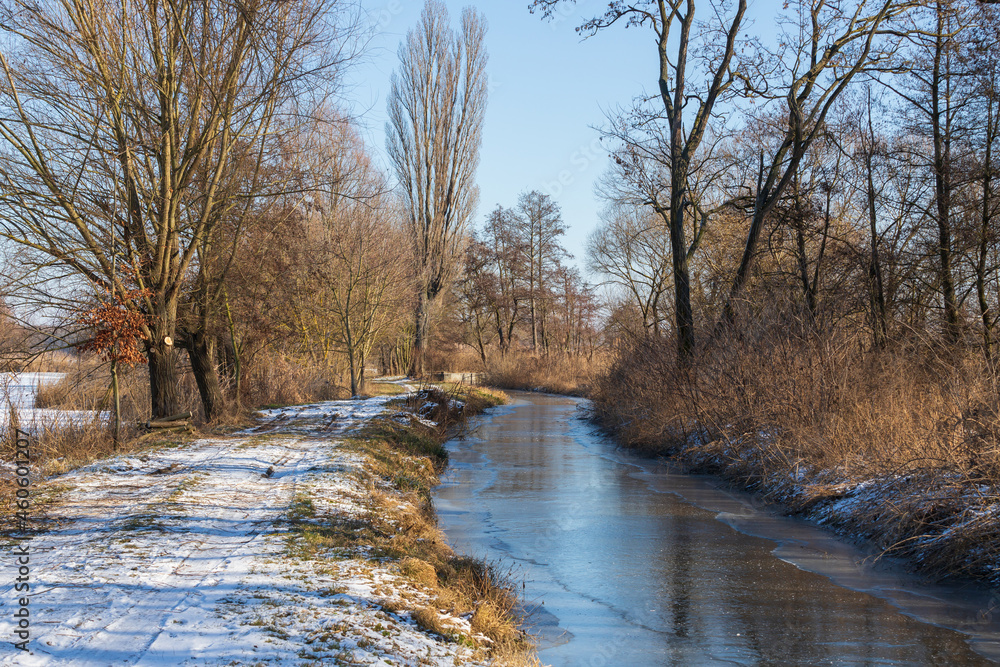 Winter landscape. Road on which there is white snow. A stream flows along the road. Winter landscape. Road on which there is white snow. A stream flows along the road.