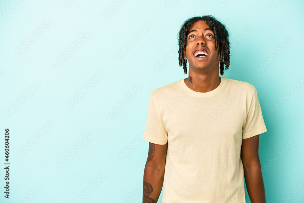 Young african american man isolated on blue background shouting very angry, rage concept, frustrated. Young african american man isolated on blue background shouting very angry, rage concept, frustrated.
