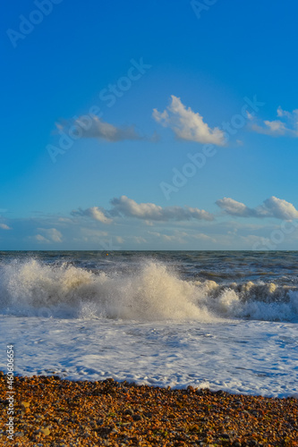 Small storm at sunset, high waves with white foam
