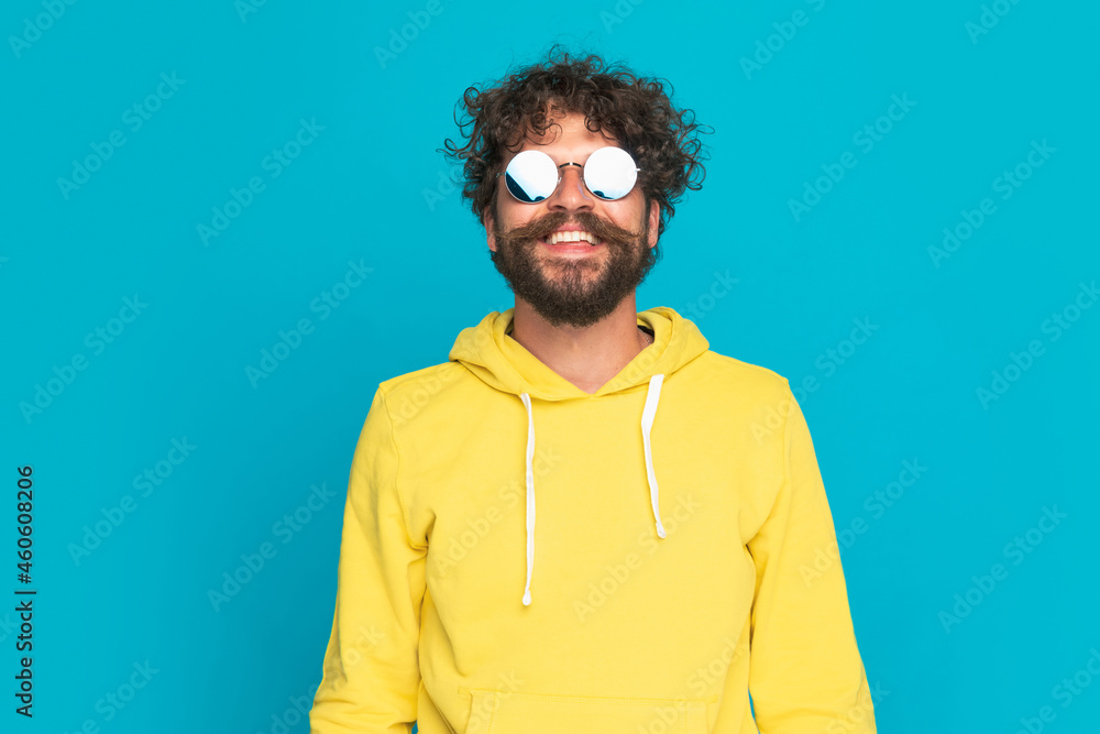 Fototapeta premium portrait of happy young man with long beard and moustache smiling