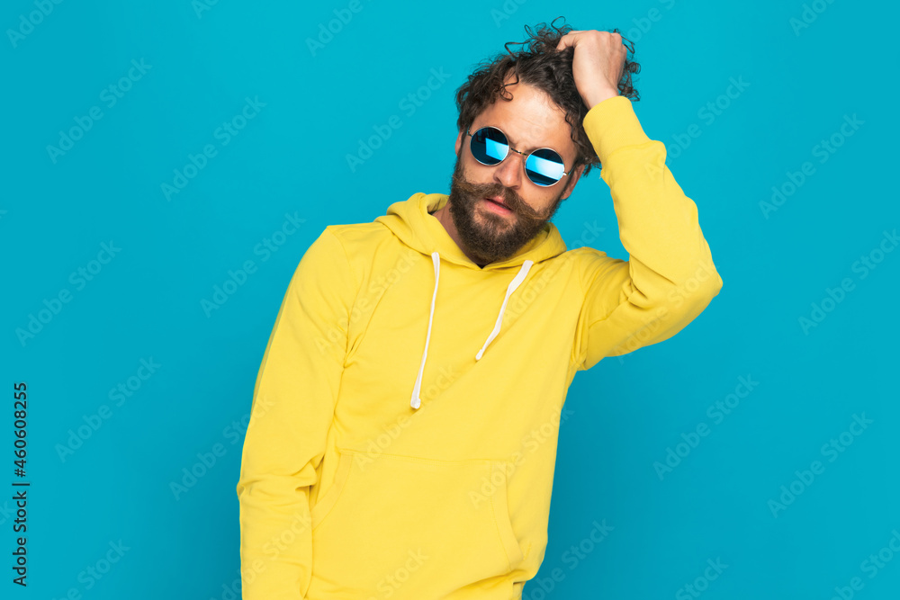 cool handsome man in yellow shirt getting fingers through hair cool handsome man in yellow shirt getting fingers through hair