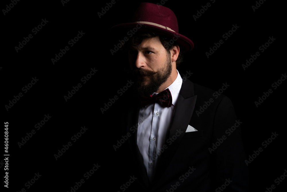 sexy businessman looking away into the dark