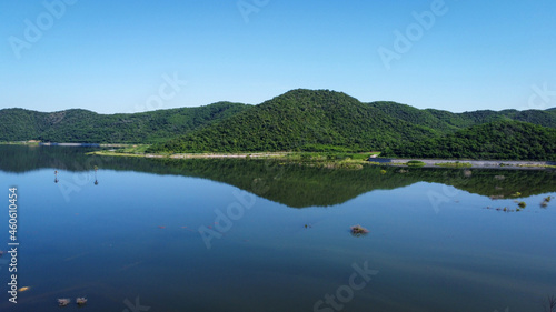 The mountains around the reservoir and the sky are beautiful.