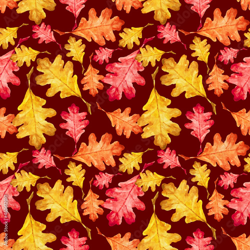 A modern seamless pattern of bright autumn leaves on a dark red background. Oak leaves. Autumn theme. Halloween. You can use it for your own design.
