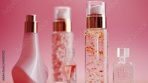 Beauty, make-up and cosmetics product promotion on pink background, perfume, fragrance and skincare bottles. High quality FullHD footage