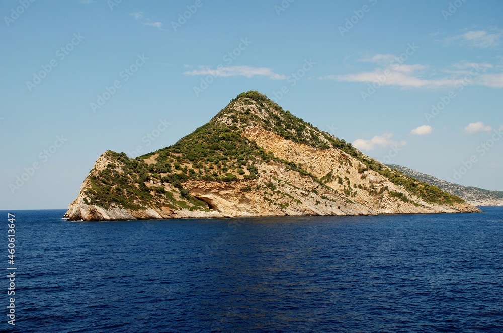 A rocky uninhabited island between the Greek islands of Skopelos and Alonissos
