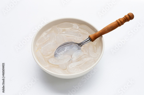 Bowl of sliced toddy palm in syrup on white background.