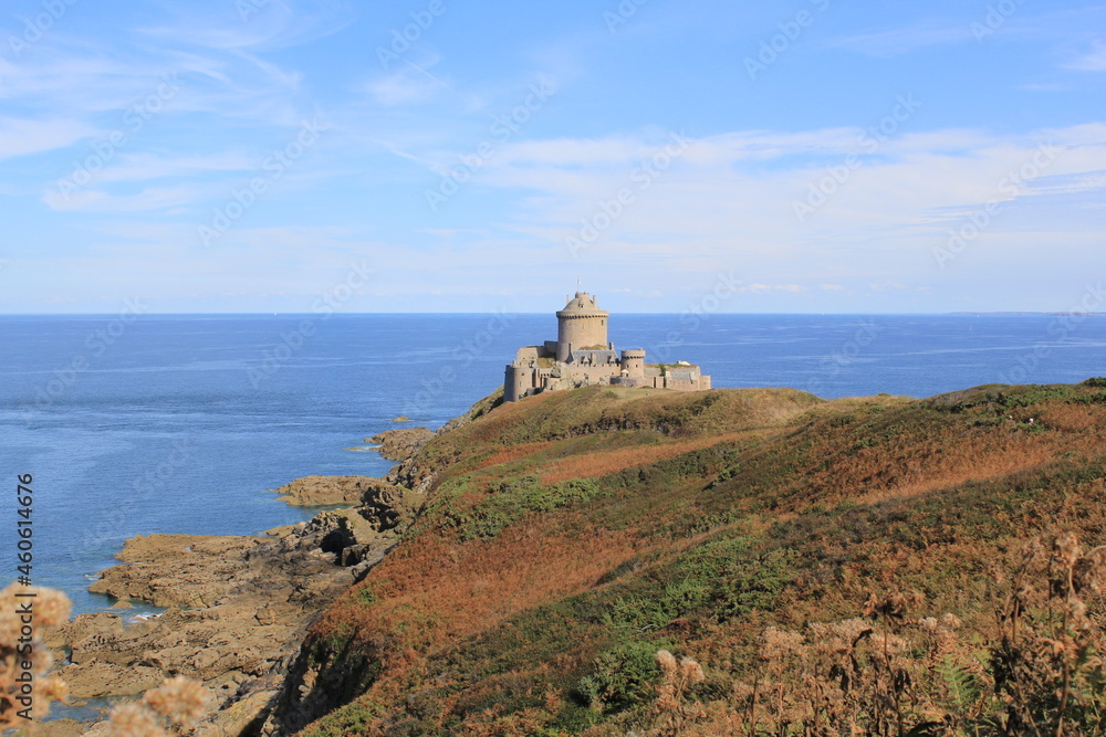 fort la latte at a colorful rock goyon at the french coast in bretagne with a deep blue sea in the background
