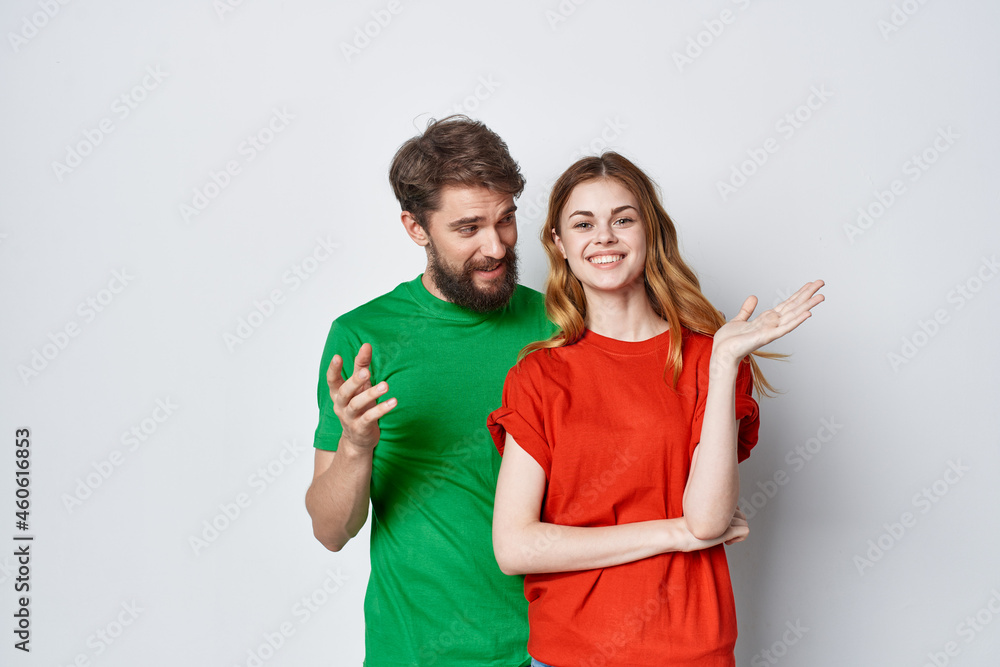 a young couple hug friendship colorful t-shirts family isolated background a young couple hug friendship colorful t-shirts family isolated background