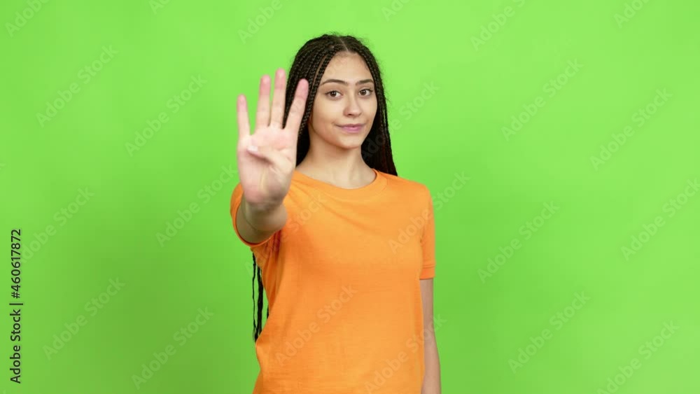 Teenager girl with braids happy and counting with fingers over isolated background. Green screen chroma key Teenager girl with braids happy and counting with fingers over isolated background. Green screen chroma key