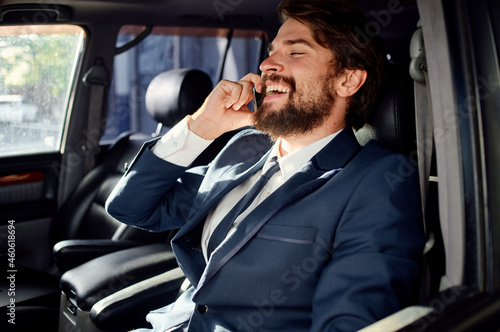 bearded man in a suit in a car a trip to work service © SHOTPRIME STUDIO