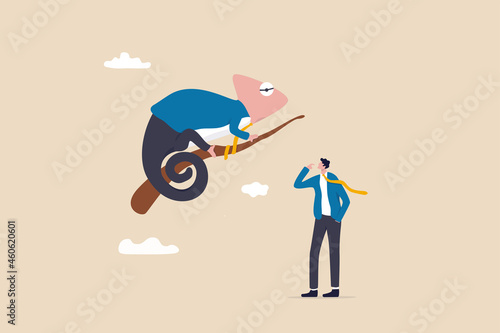 Business adaptability, change or evolve in uncertainty to survive and success, resilience or flexibility concept, businessman looking at chameleon reptile that evolved or transform into business suit.