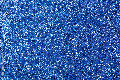 Blue glitter texture background, glitter or sandpapper high detailed surface, shining glowing effects concept