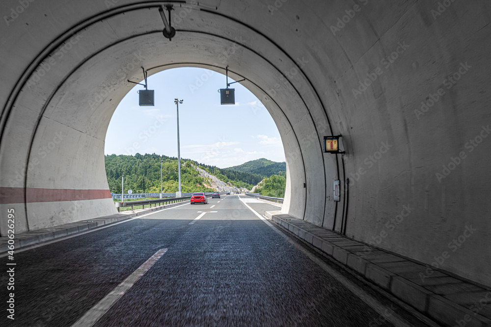 Concrete tunnel with asphalt road on the highway.
