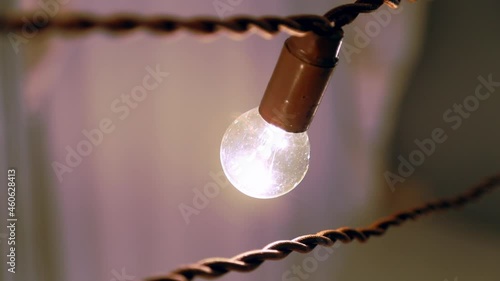 Close-up of a light bulb hanging on twisted wires